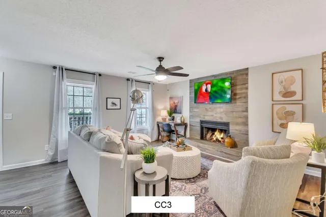 a living room with fireplace furniture and a flat screen tv