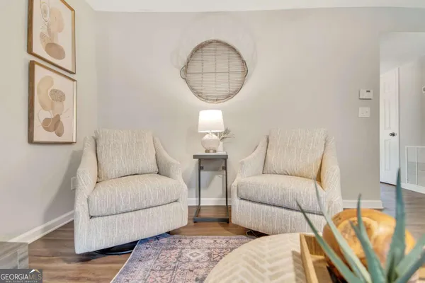a living room with furniture a couch and a chandelier