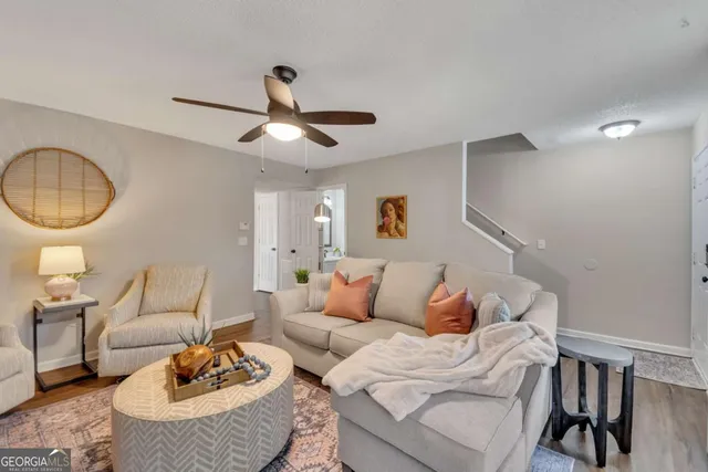 a living room with furniture a rug and a chandelier