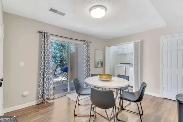 a view of a dining room with furniture window and wooden floor