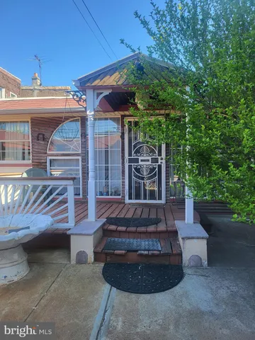 a view of a patio with table and chairs with wooden fence and plants
