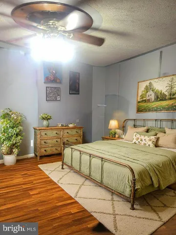 a bedroom with a large bed and a chandelier