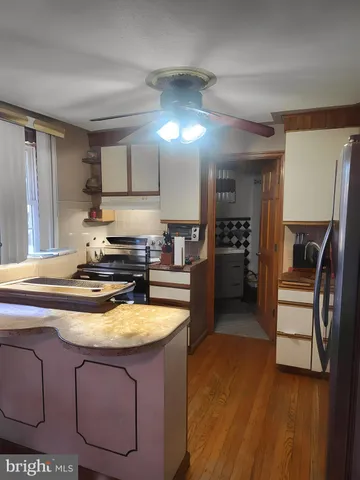 a kitchen with stainless steel appliances granite countertop a sink a stove and a refrigerator