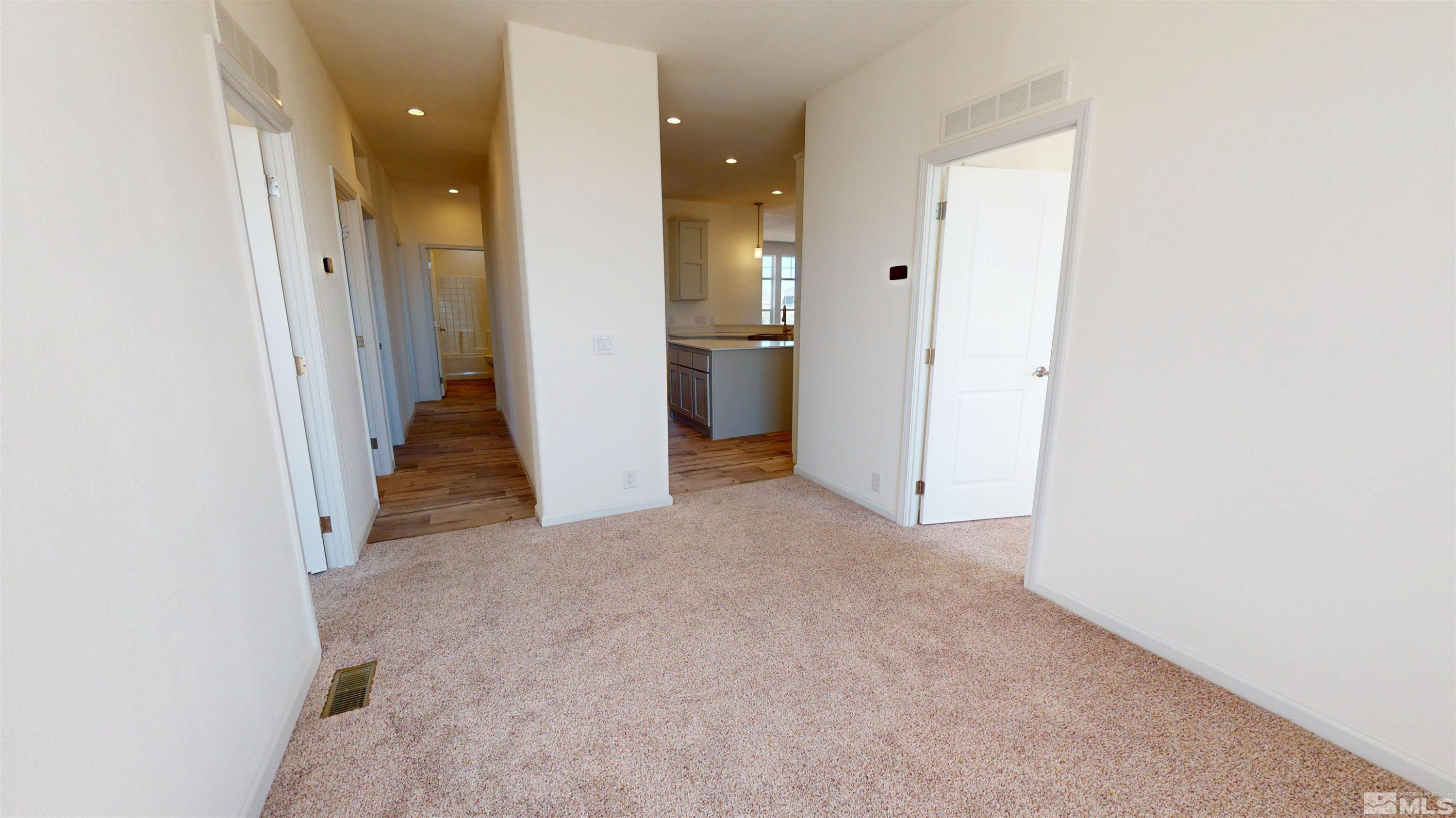 7275 West Rose Creek Road Winnemucca, NV 89445 - Photo 16 of 25 a view of a hallway with wooden floor and a bathroom
