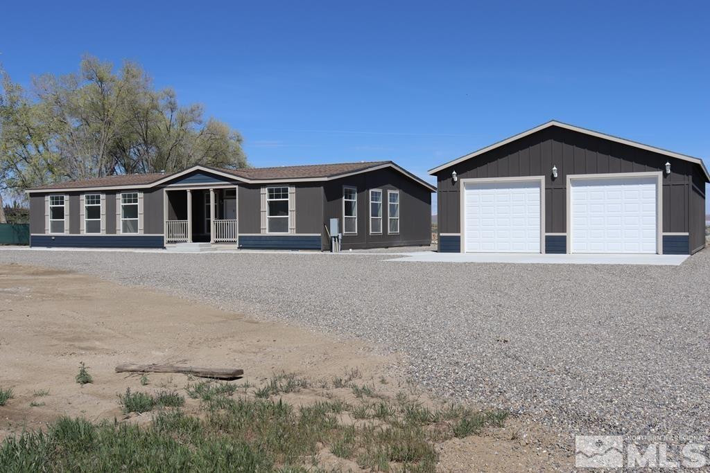 7275 West Rose Creek Road Winnemucca, NV 89445 - Photo 23 of 25 a front view of a house with yard and trees around