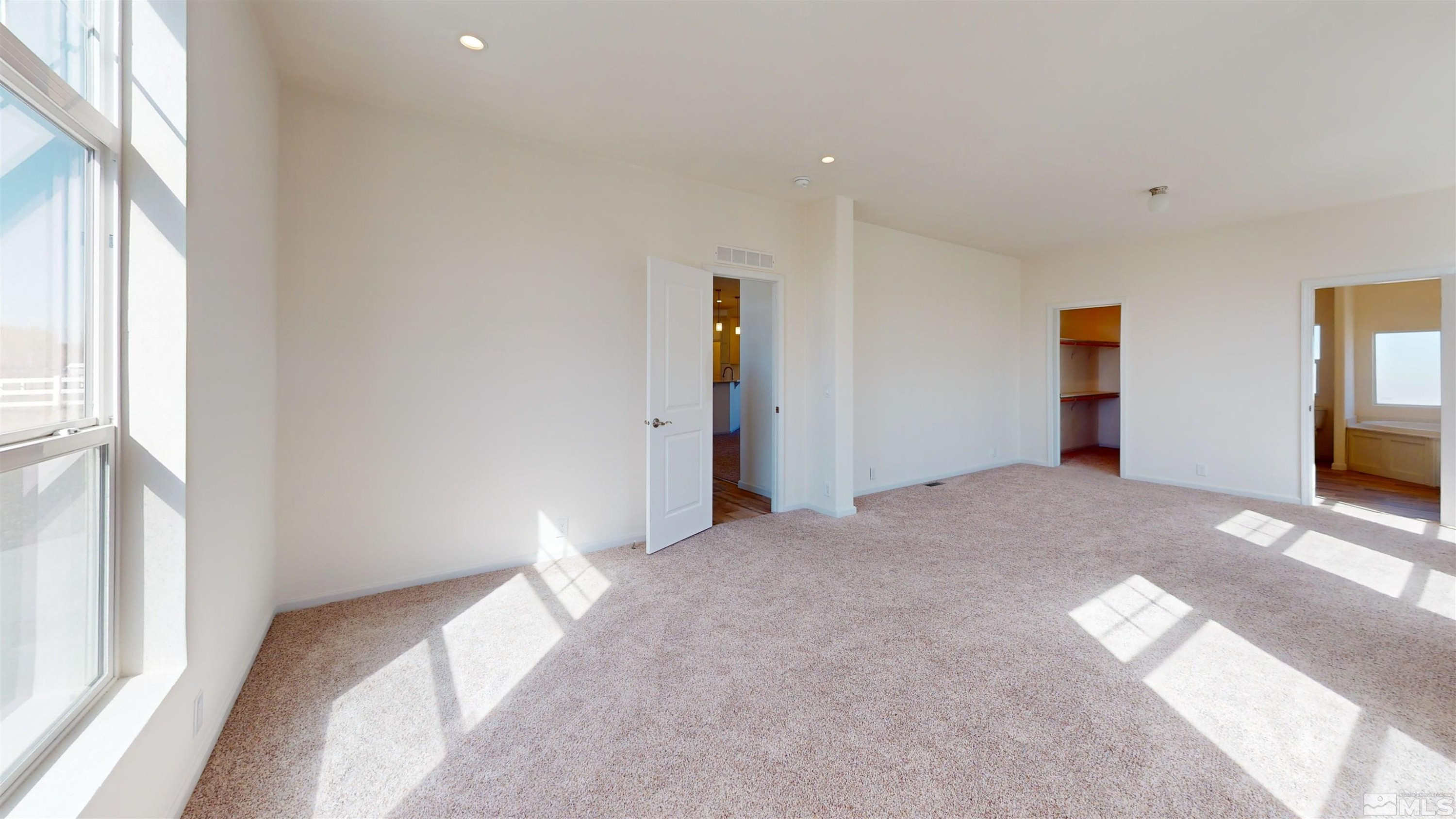 7275 West Rose Creek Road Winnemucca, NV 89445 - Photo 5 of 25 a bedroom with a bed and a large window