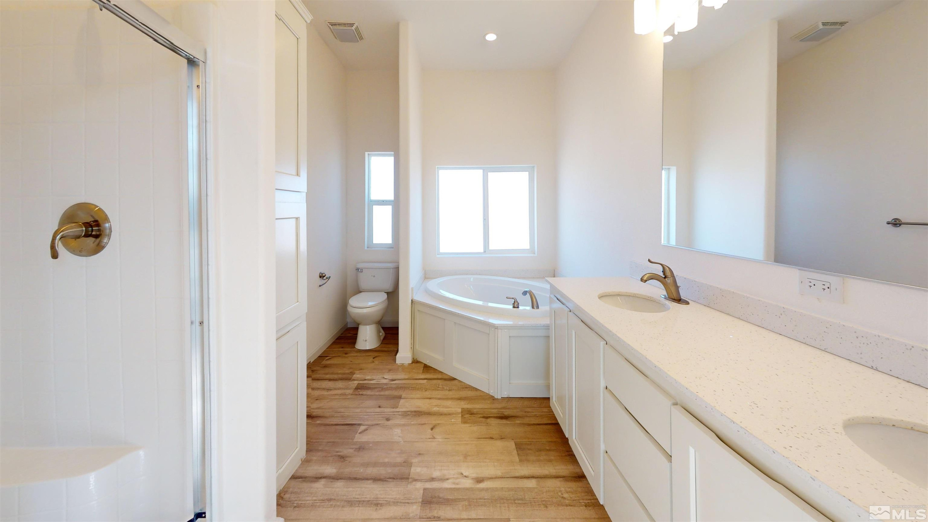 7275 West Rose Creek Road Winnemucca, NV 89445 - Photo 6 of 25 a bathroom with a tub sink and mirror
