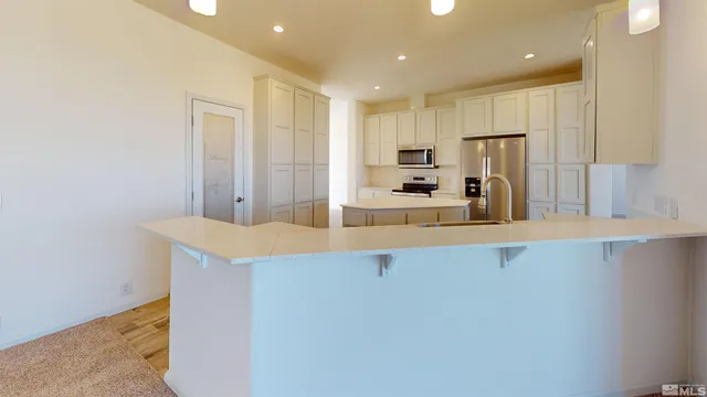 a kitchen with stainless steel appliances a refrigerator and a sink