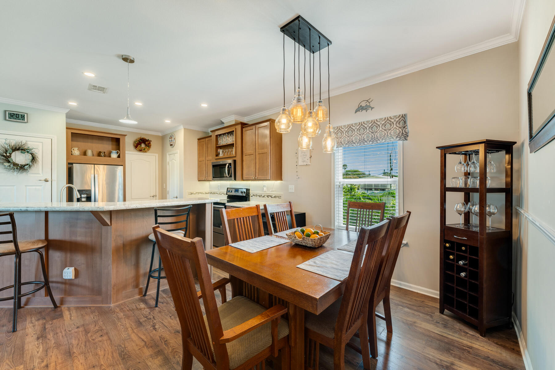 650 64th Street Marathon, FL 33050 - Photo 15 of 45 a view of a dining room and livingroom with furniture wooden floor a rug a chandelier
