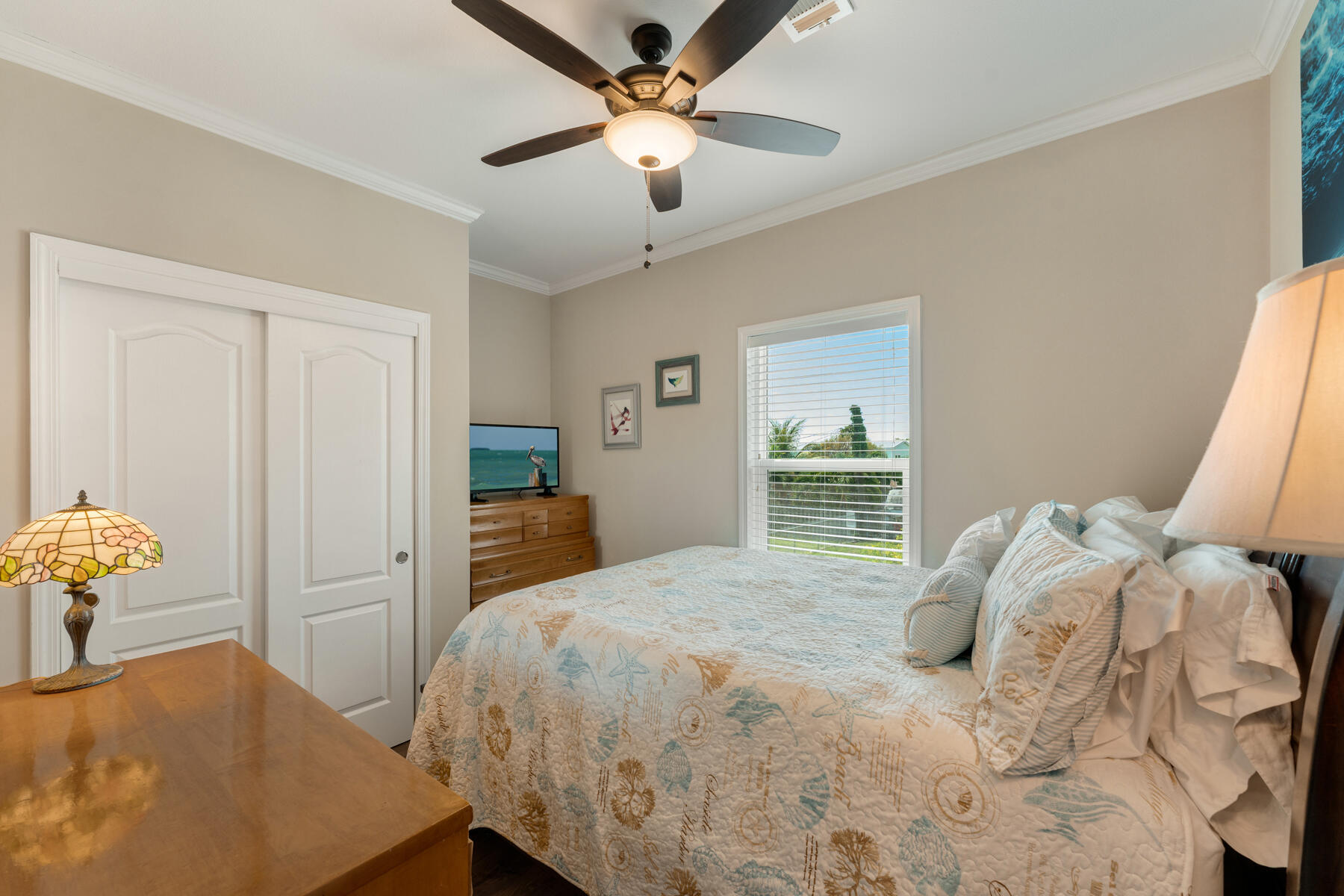 650 64th Street Marathon, FL 33050 - Photo 26 of 45 a bedroom with a bed and a chandelier