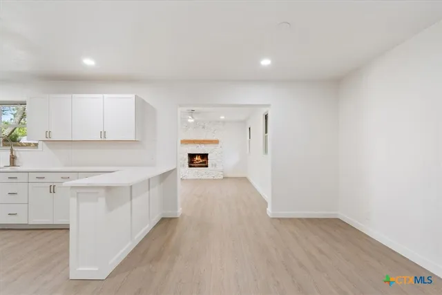 a kitchen with a sink dishwasher a stove and a refrigerator with wooden floor