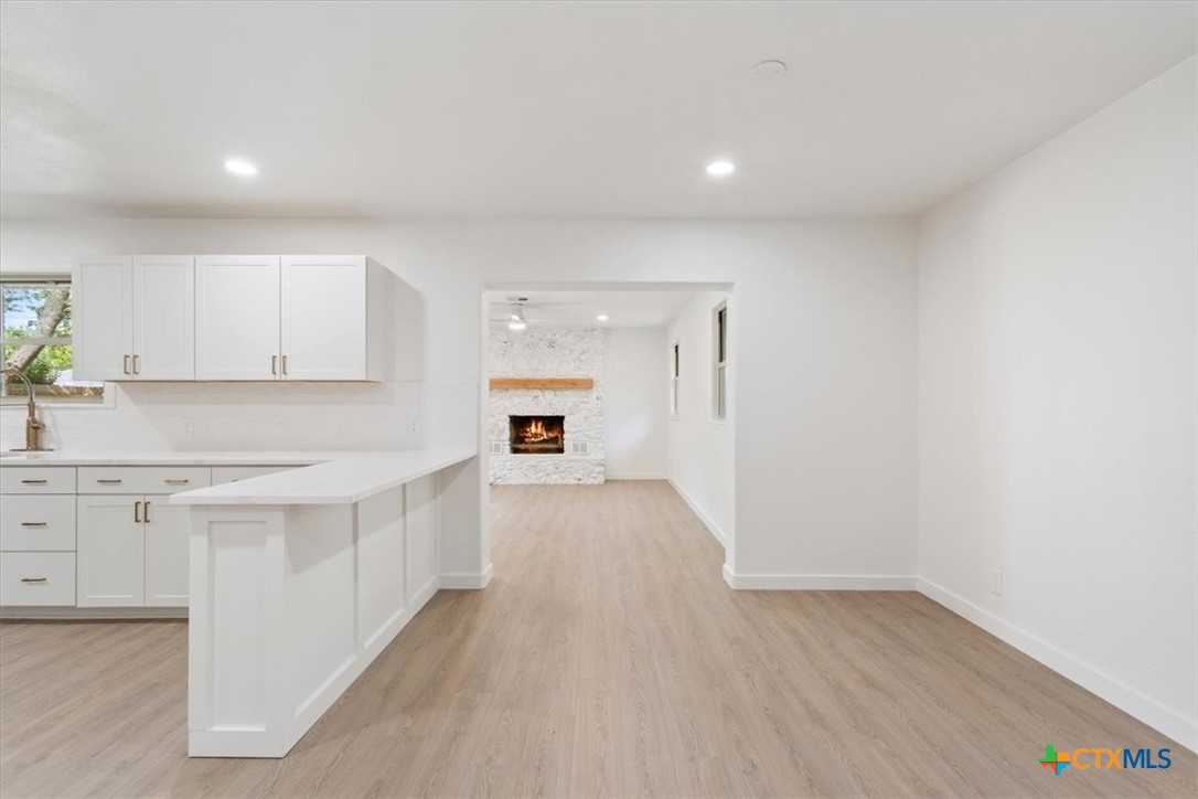 4412 Briar Cliff Road Temple, TX 76502 - Photo 11 of 35 a view of kitchen with granite countertop cabinets and wooden floor