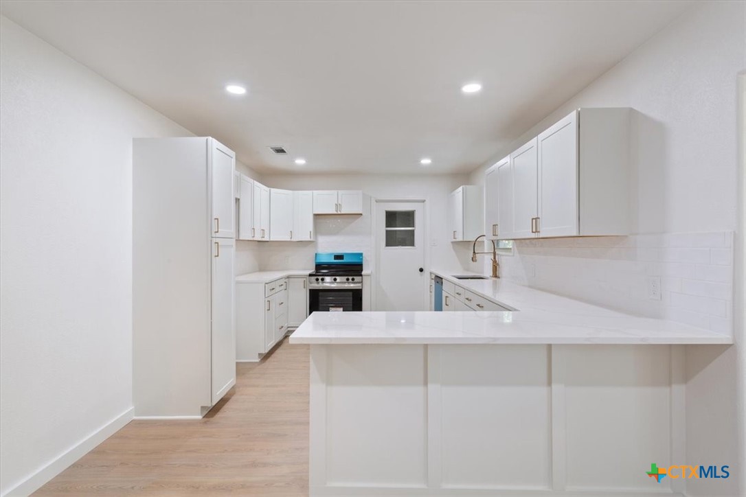 4412 Briar Cliff Road Temple, TX 76502 - Photo 13 of 35 a kitchen with white cabinets and refrigerator