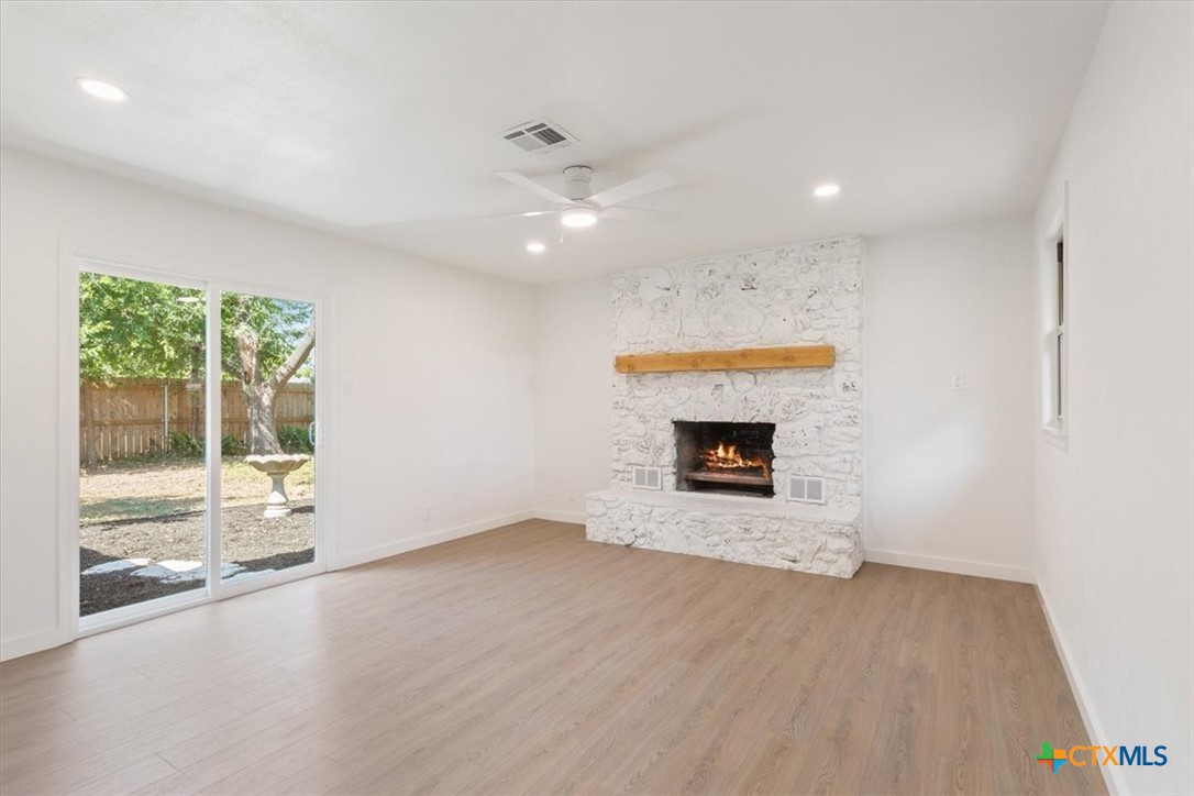 4412 Briar Cliff Road Temple, TX 76502 - Photo 19 of 35 a view of an empty room with a fireplace and a window