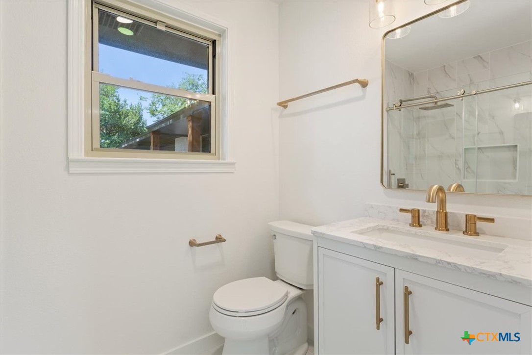4412 Briar Cliff Road Temple, TX 76502 - Photo 26 of 35 a bathroom with a sink a toilet and a mirror
