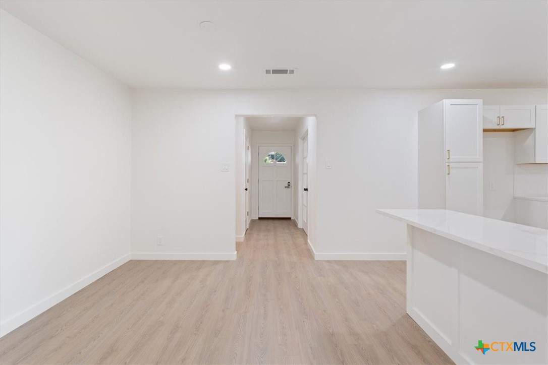4412 Briar Cliff Road Temple, TX 76502 - Photo 10 of 35 a view of an empty room with wooden floor and a window