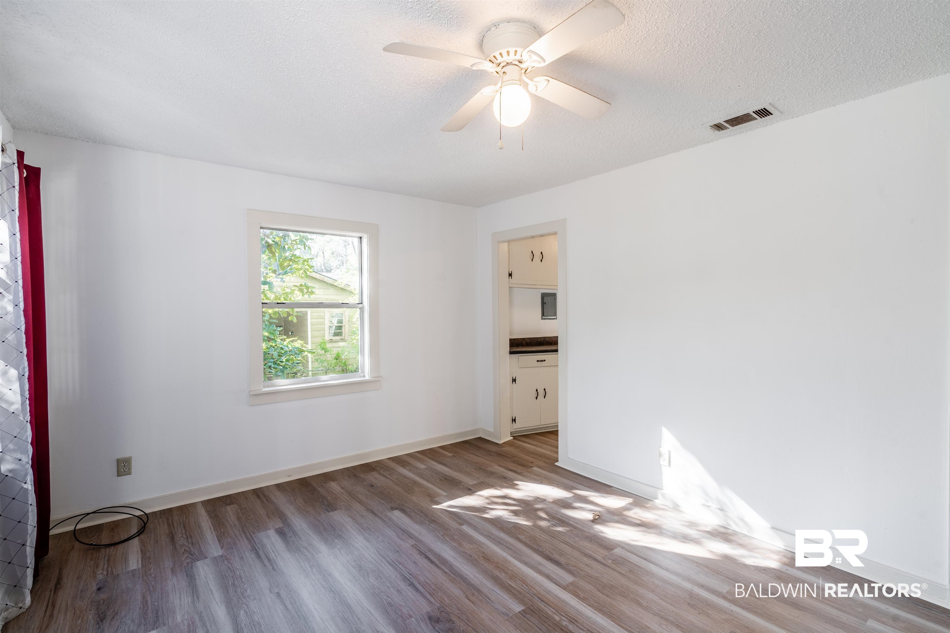 3900 Brookmont Drive Mobile, AL 36605 - Photo 4 of 19 Spare room featuring a textured ceiling, ceiling fan, and wood-type flooring