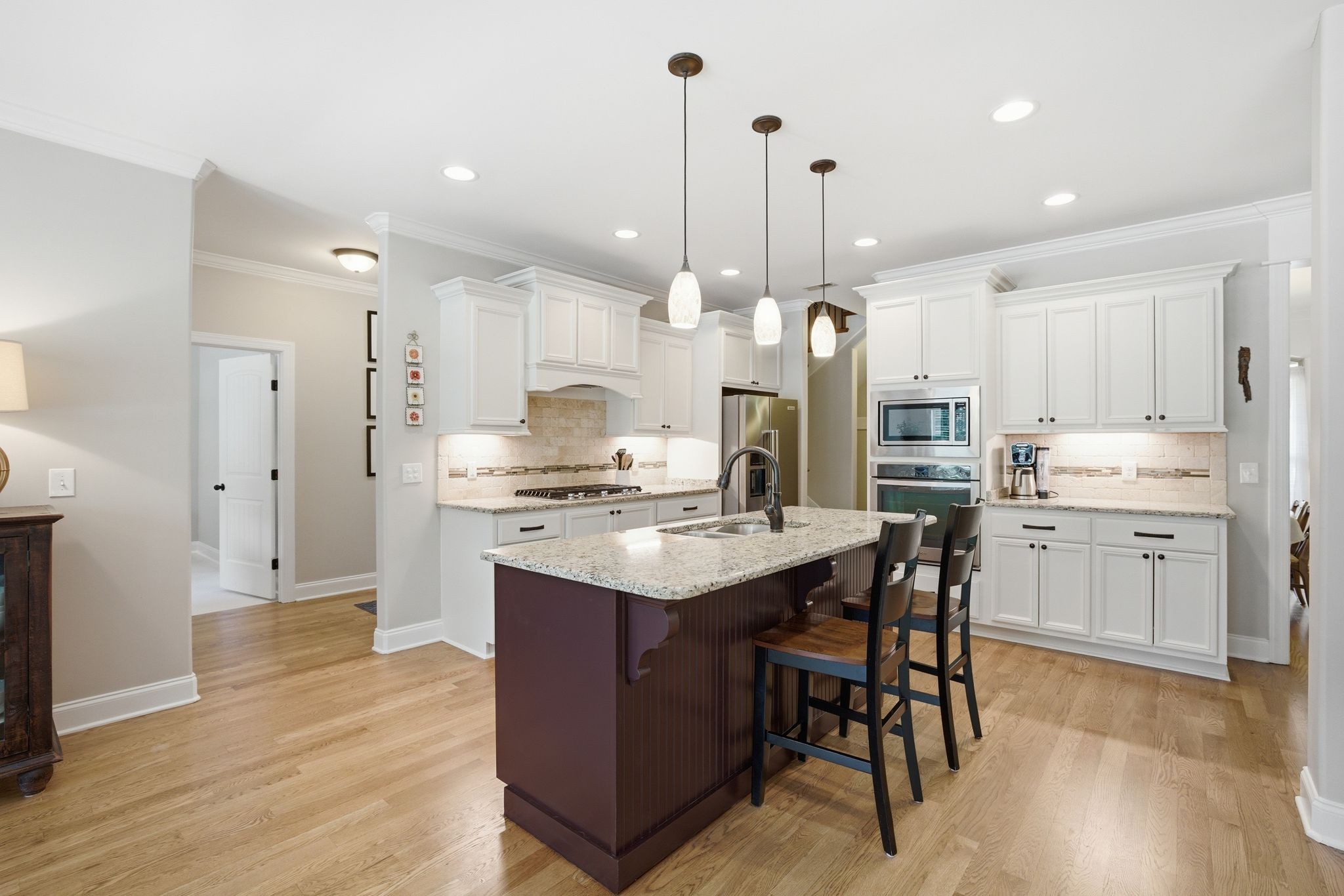 211 Fox Den Way Murfreesboro, TN 37130 - Photo 11 of 64 a kitchen with kitchen island granite countertop a sink a stove a refrigerator and island with wooden floor