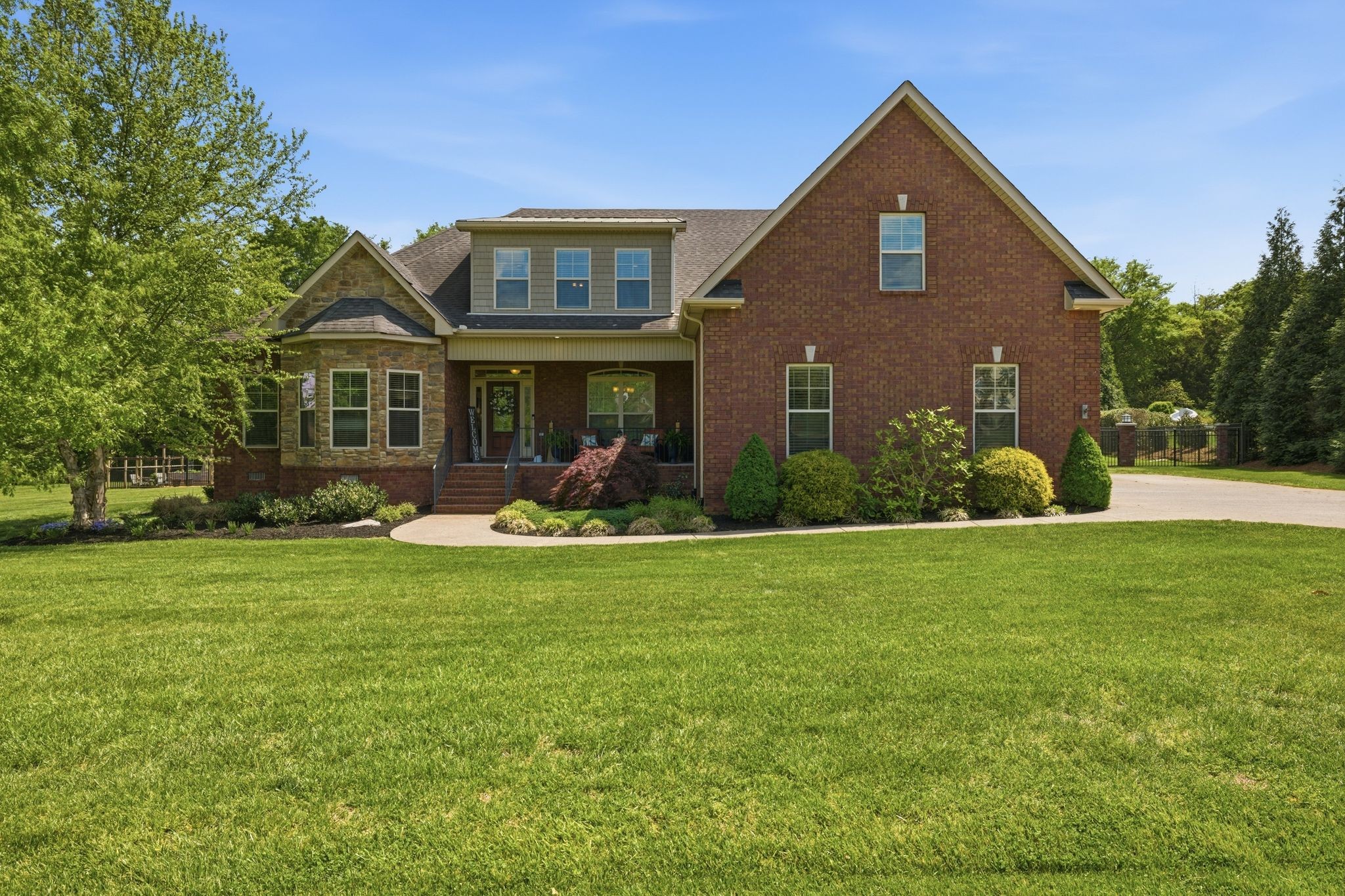 211 Fox Den Way Murfreesboro, TN 37130 - Photo 3 of 64 a front view of a house with porch and garden