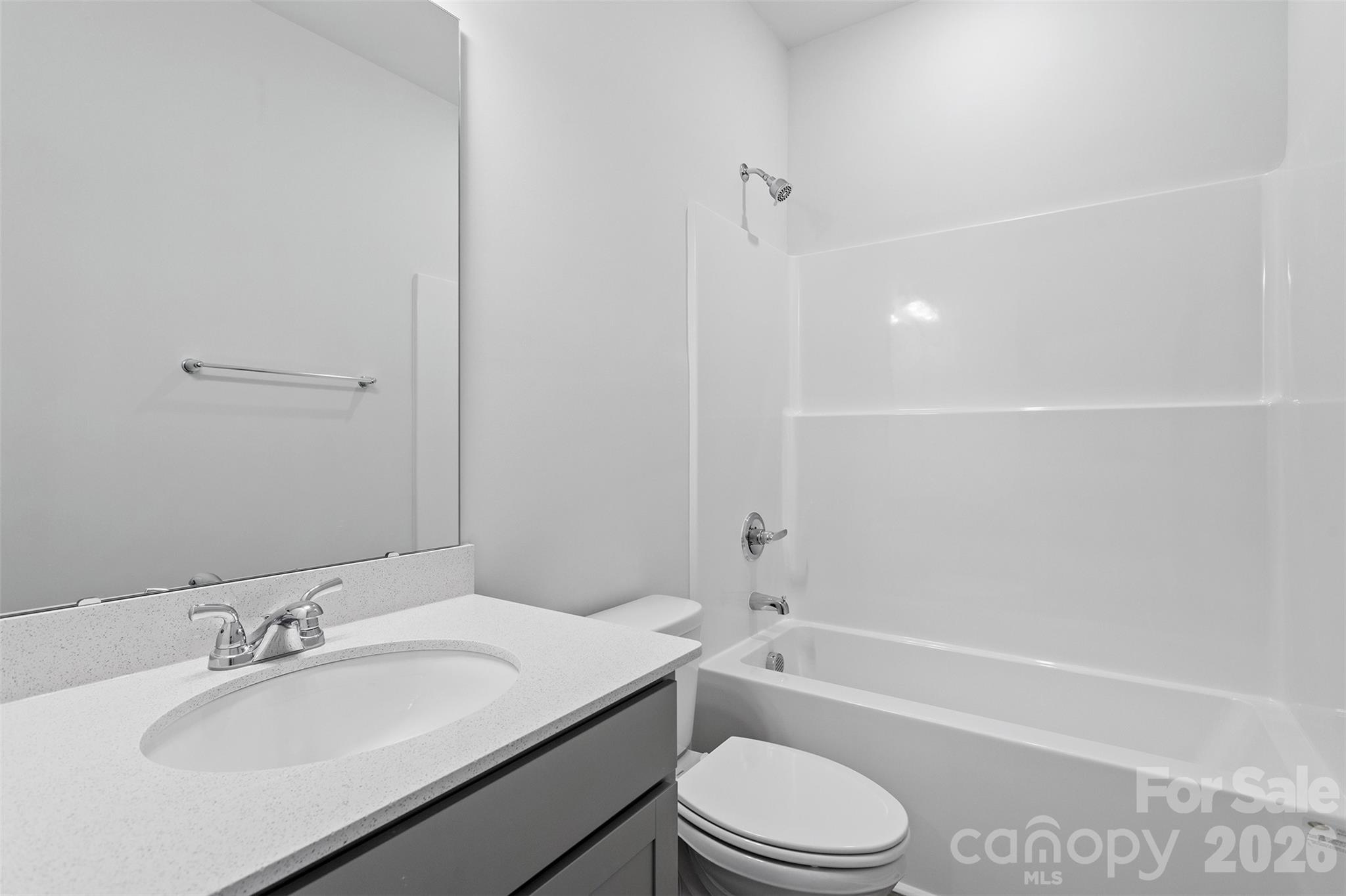 5835 Tuckaseegee Road, Unit 9 Charlotte, NC 28208 - Photo 23 of 29 a bathroom with a granite countertop sink toilet a mirror and shower