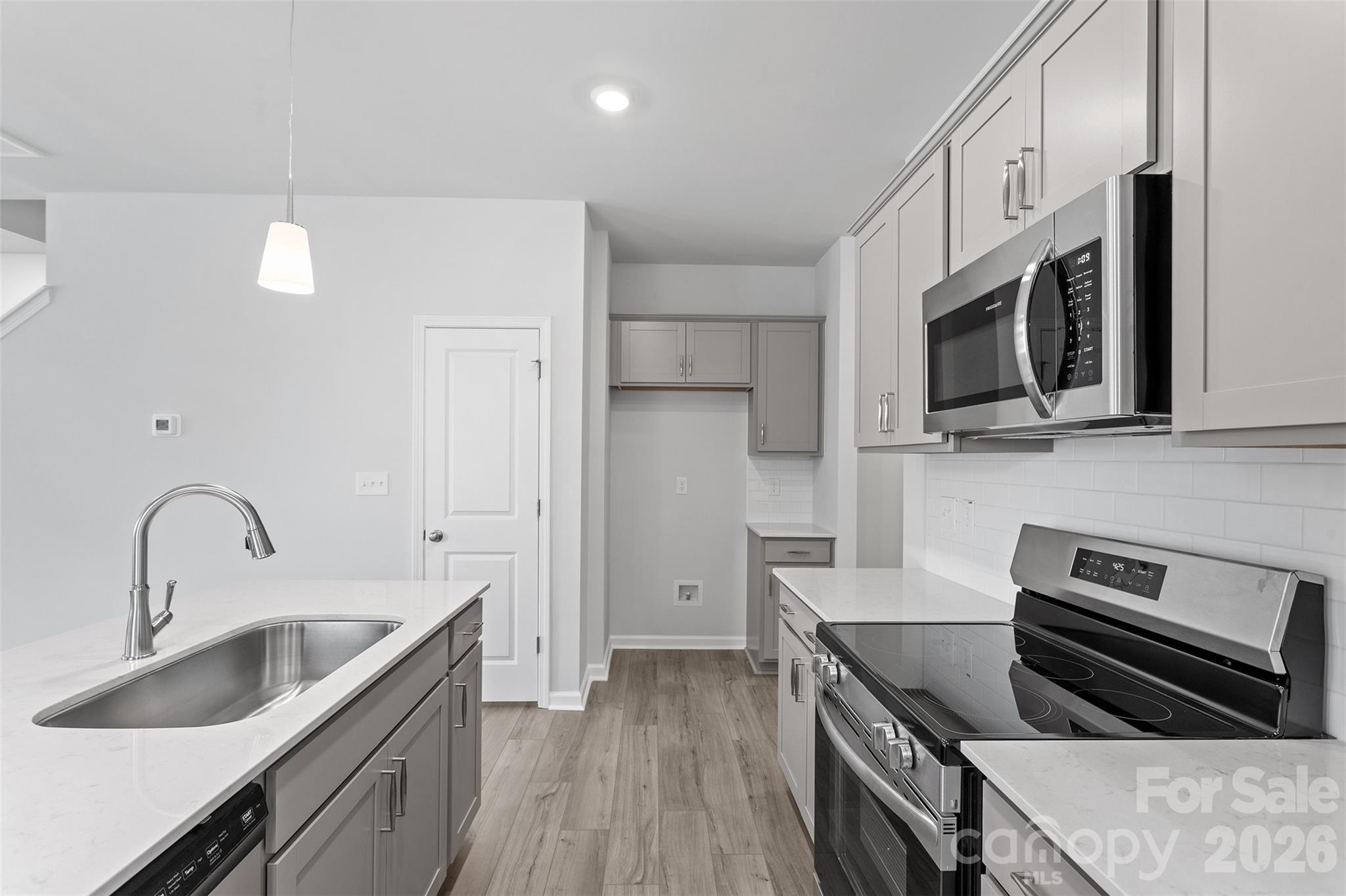 5835 Tuckaseegee Road, Unit 9 Charlotte, NC 28208 - Photo 5 of 29 a kitchen with stainless steel appliances granite countertop a sink stove and refrigerator