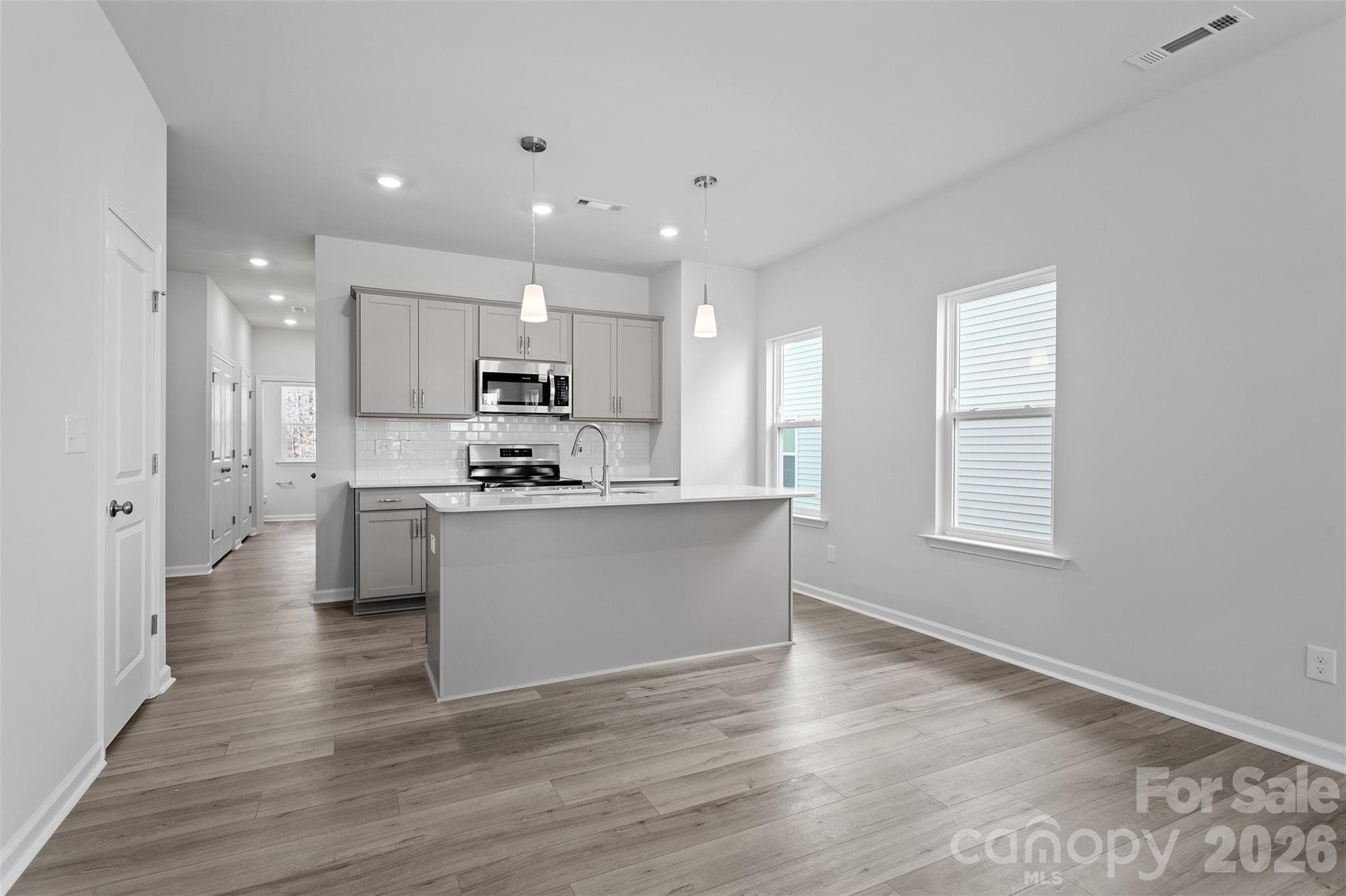 5835 Tuckaseegee Road, Unit 9 Charlotte, NC 28208 - Photo 10 of 29 a kitchen with a refrigerator and a stove top oven