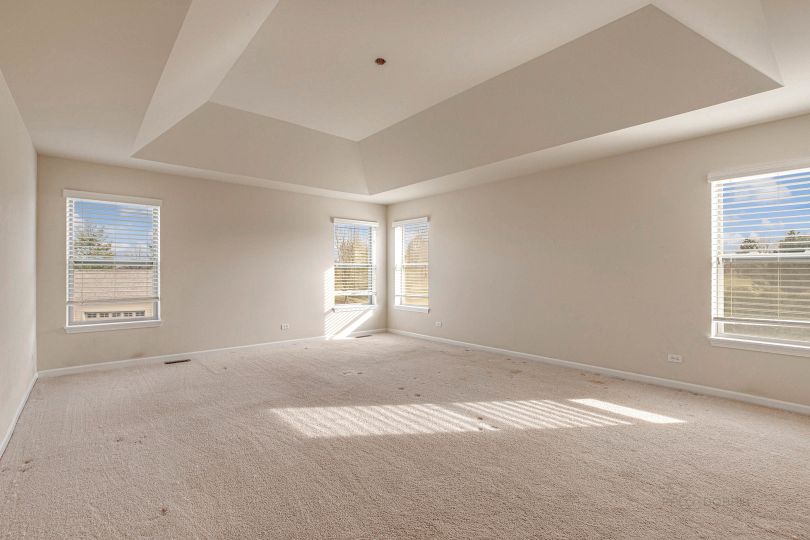 2479 Downing Court Gurnee, IL 60031 - Photo 13 of 21 a view of a big room with windows and chandelier fan