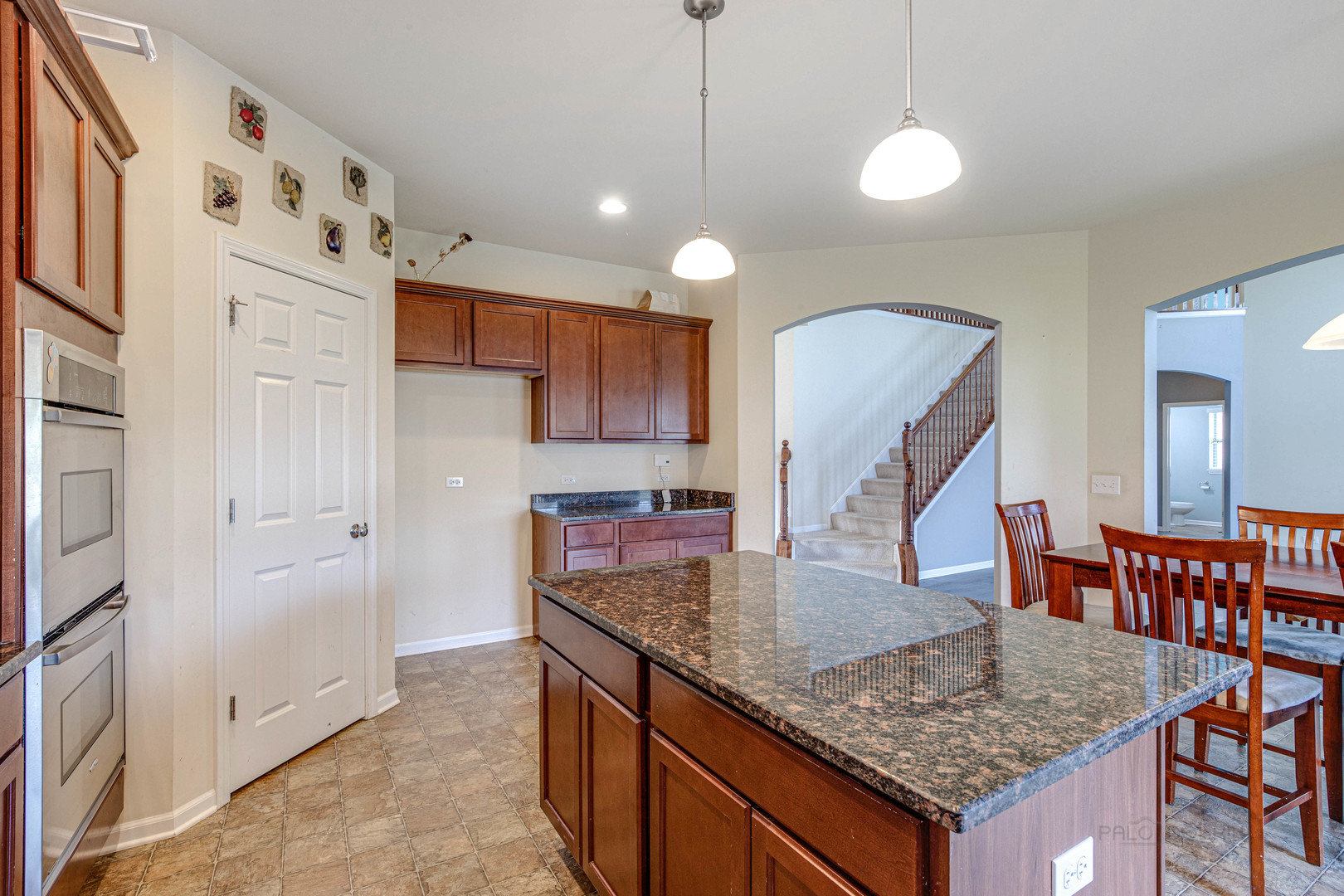 2479 Downing Court Gurnee, IL 60031 - Photo 8 of 21 a kitchen with stainless steel appliances granite countertop a sink and a refrigerator
