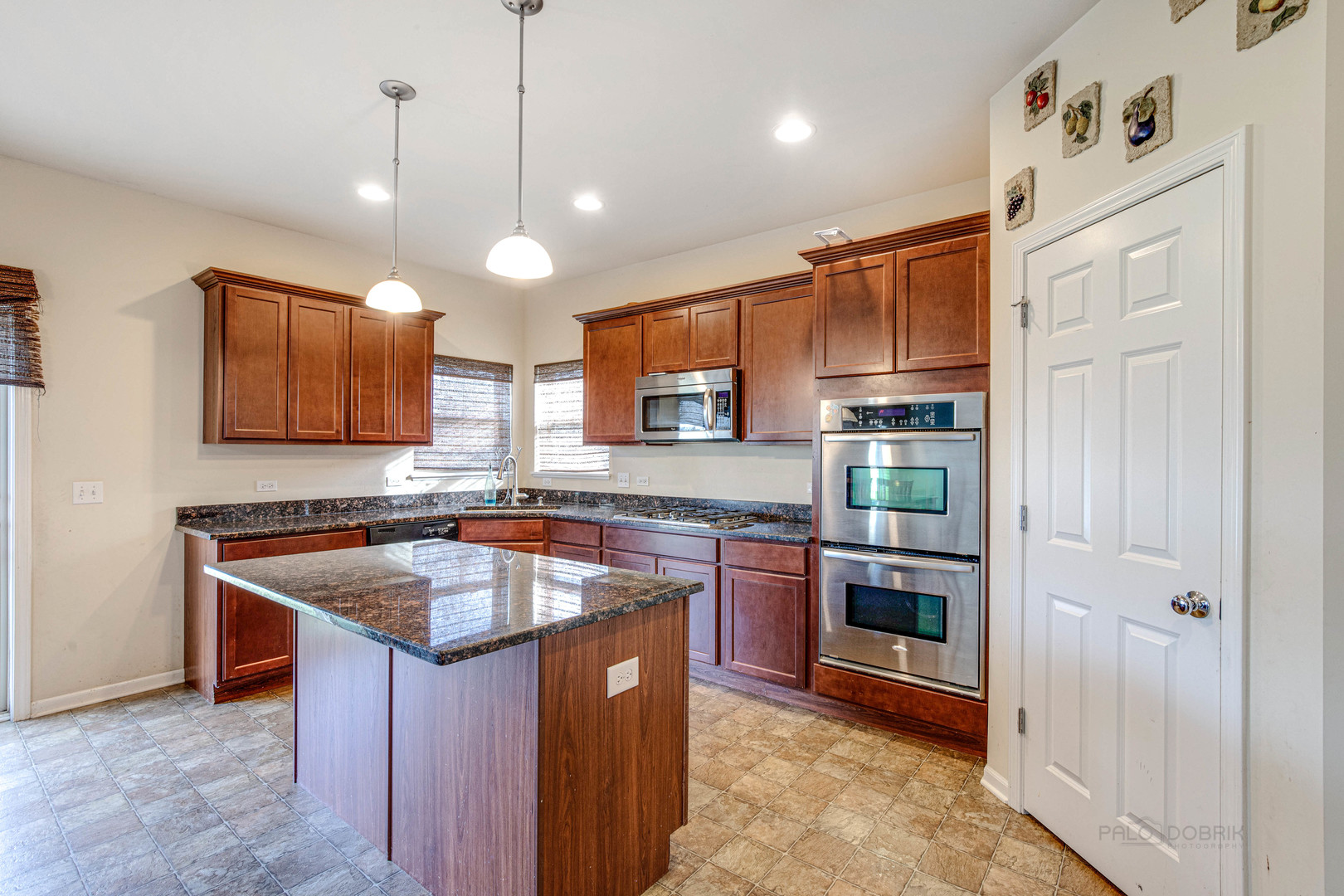 2479 Downing Court Gurnee, IL 60031 - Photo 9 of 21 a kitchen with stainless steel appliances granite countertop a sink a stove and a refrigerator