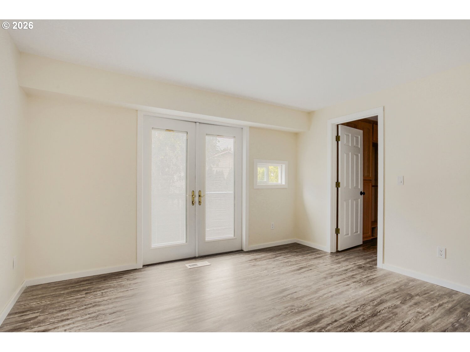 14539 Southeast Center Street Portland, OR 97236 - Photo 13 of 30 a view of an empty room with wooden floor & closet