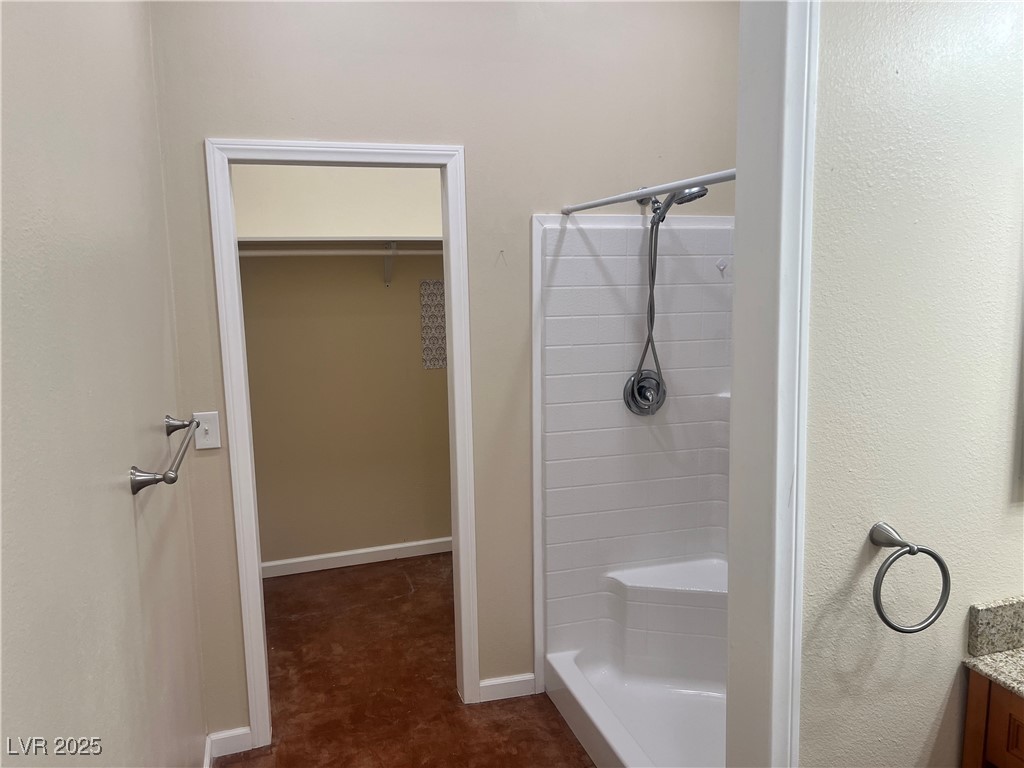 520 Burt Street Pahrump, NV 89060 - Photo 43 of 99 Bath with vanity, a shower stall, and a walk in closet