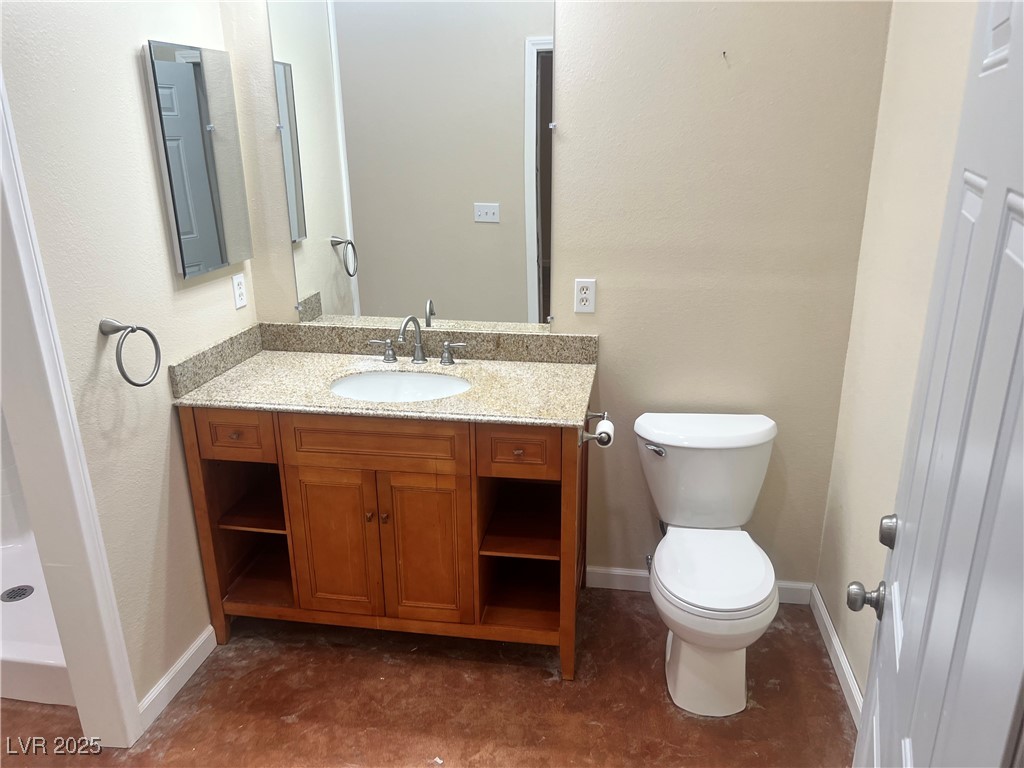 520 Burt Street Pahrump, NV 89060 - Photo 44 of 99 Bathroom with vanity, a stall shower, and a textured wall