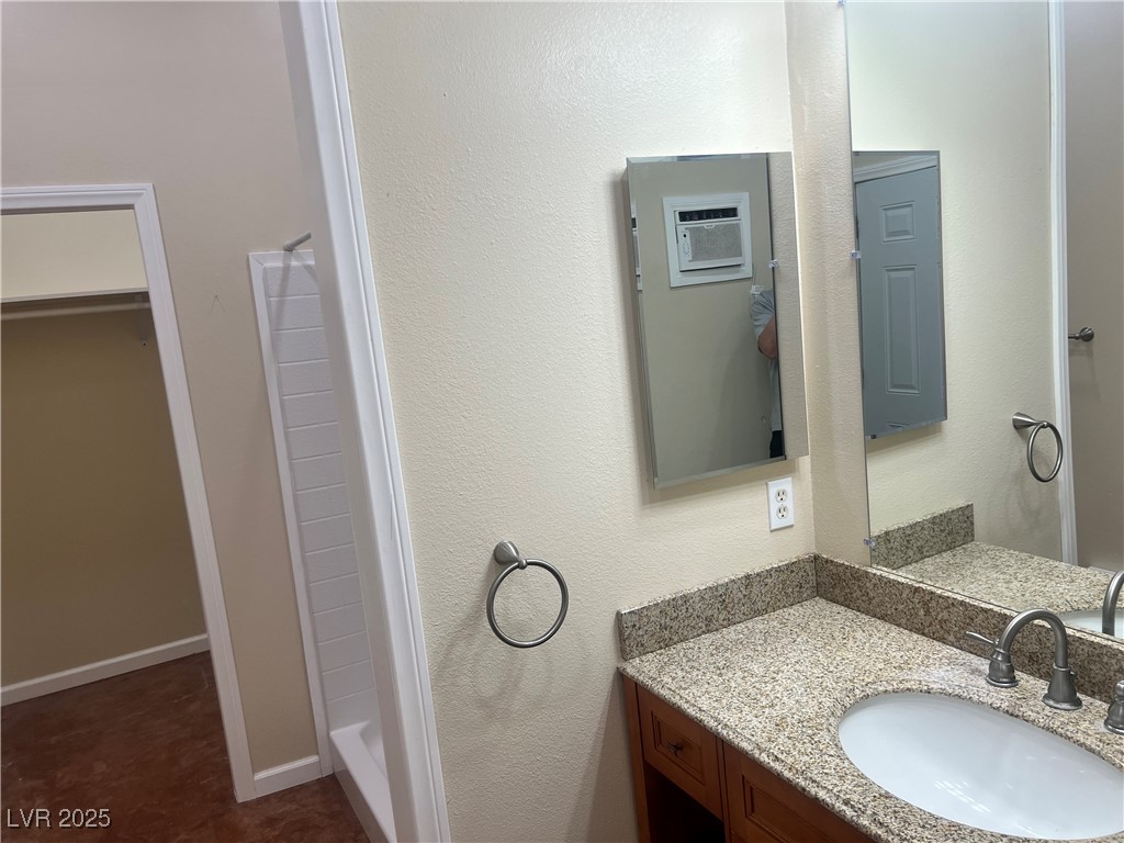 520 Burt Street Pahrump, NV 89060 - Photo 48 of 99 Bathroom featuring a textured wall, vanity, and a shower