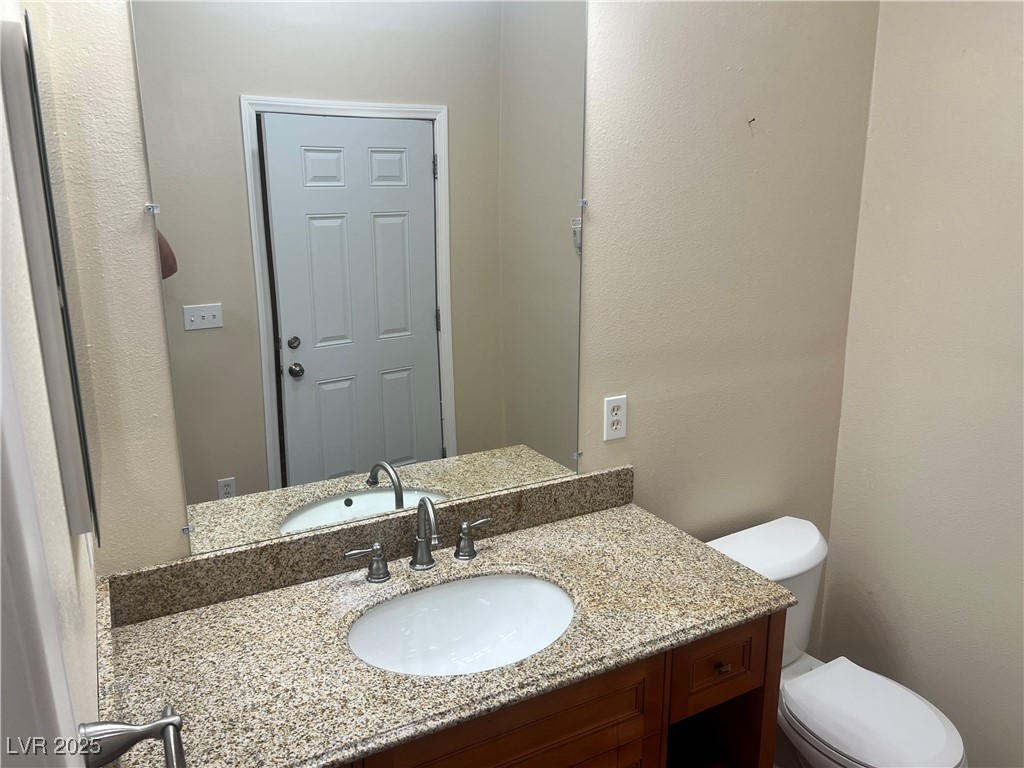 520 Burt Street Pahrump, NV 89060 - Photo 49 of 99 Bathroom with a textured wall and vanity