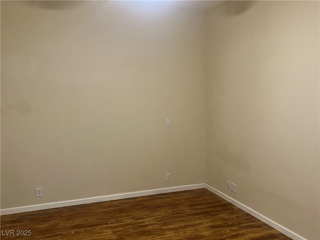 520 Burt Street Pahrump, NV 89060 - Photo 54 of 99 Empty room with dark wood-style floors and baseboards
