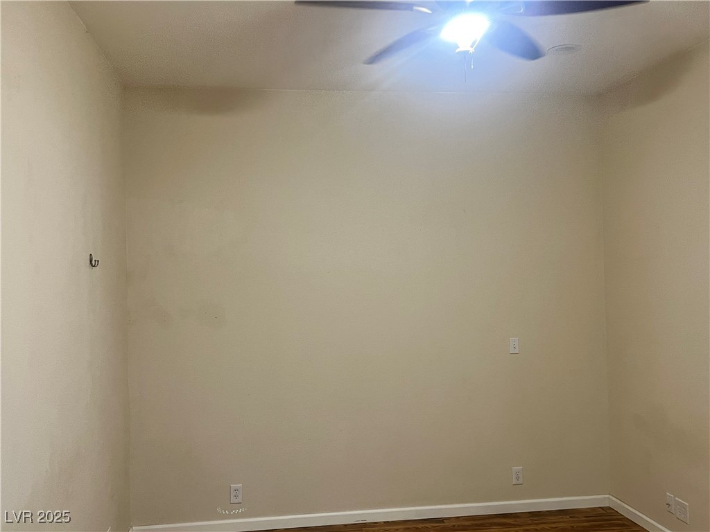 520 Burt Street Pahrump, NV 89060 - Photo 56 of 99 Spare room featuring dark wood-style flooring and a ceiling fan