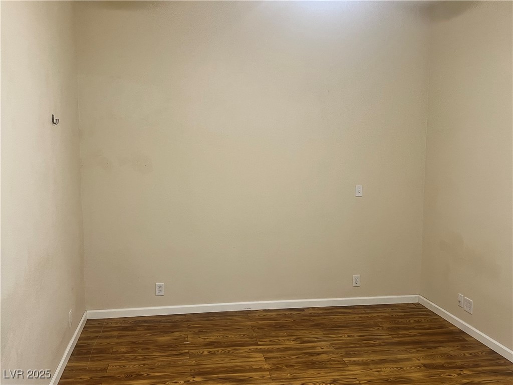 520 Burt Street Pahrump, NV 89060 - Photo 57 of 99 Empty room featuring baseboards and dark wood-type flooring
