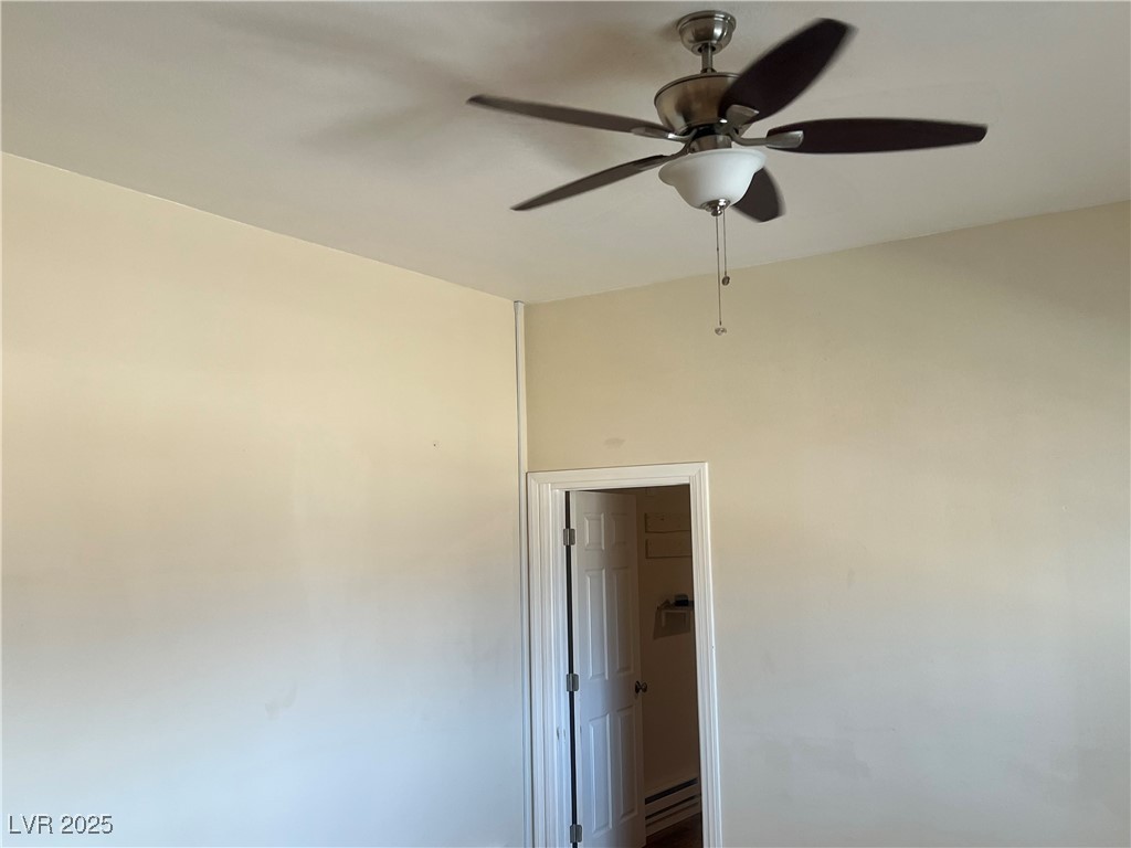 520 Burt Street Pahrump, NV 89060 - Photo 59 of 99 Unfurnished room with a baseboard radiator and a ceiling fan
