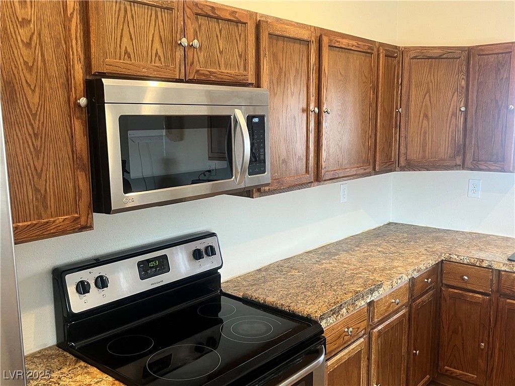 520 Burt Street Pahrump, NV 89060 - Photo 63 of 99 Kitchen featuring stainless steel appliances and brown cabinets