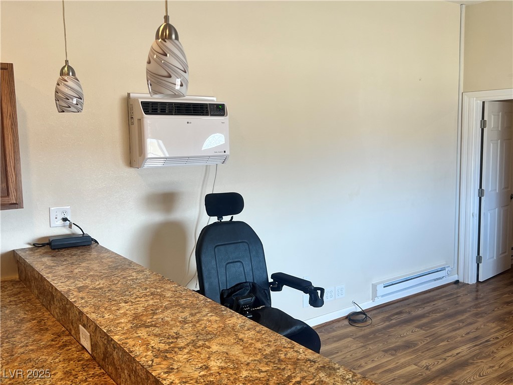 520 Burt Street Pahrump, NV 89060 - Photo 66 of 99 Detailed view of a baseboard heating unit, wood finished floors, and an office area