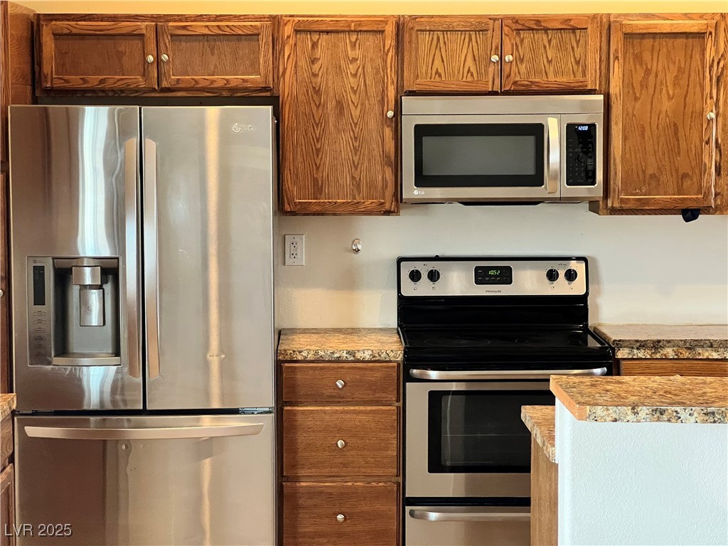 520 Burt Street Pahrump, NV 89060 - Photo 71 of 99 Kitchen featuring appliances with stainless steel finishes and brown cabinetry