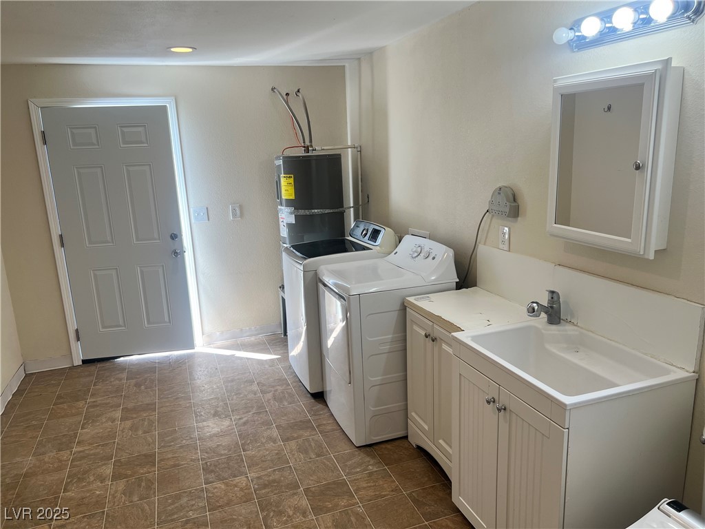 520 Burt Street Pahrump, NV 89060 - Photo 73 of 99 Washroom with electric water heater, independent washer and dryer, and cabinet space