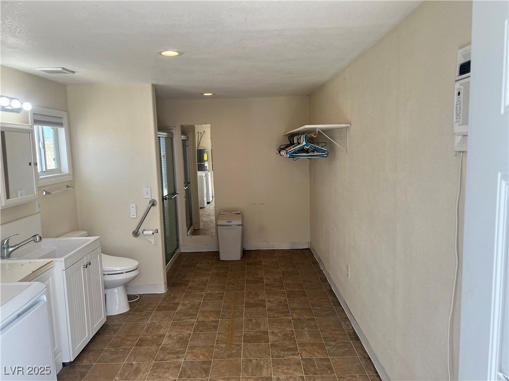520 Burt Street Pahrump, NV 89060 - Photo 78 of 99 Bathroom with vanity, a shower stall, washer / clothes dryer, and recessed lighting
