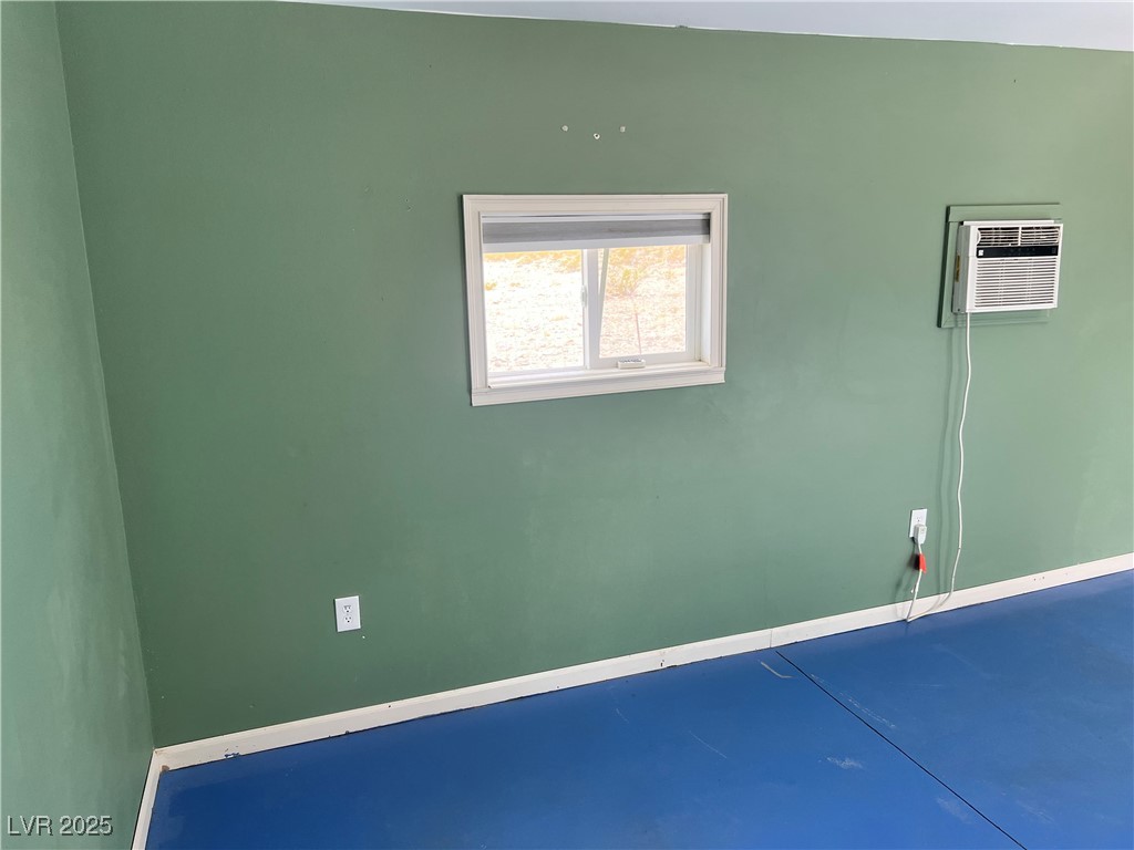 520 Burt Street Pahrump, NV 89060 - Photo 82 of 99 Spare room with finished concrete flooring and a wall unit AC