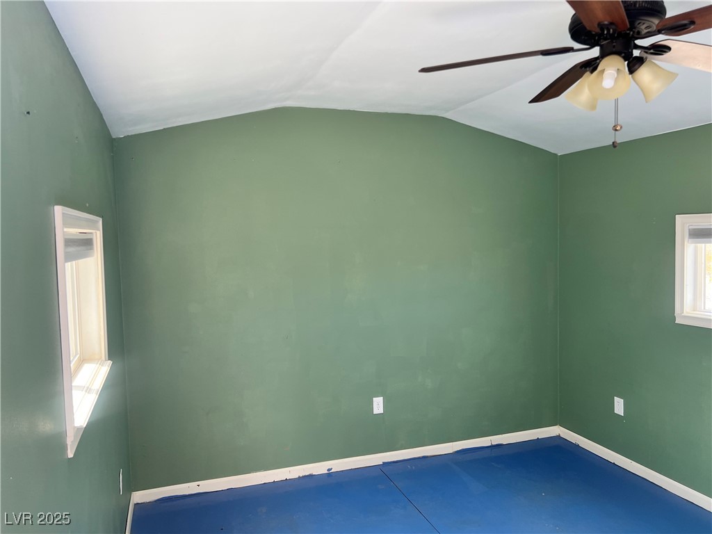 520 Burt Street Pahrump, NV 89060 - Photo 84 of 99 Unfurnished room with lofted ceiling, ceiling fan, and concrete floors