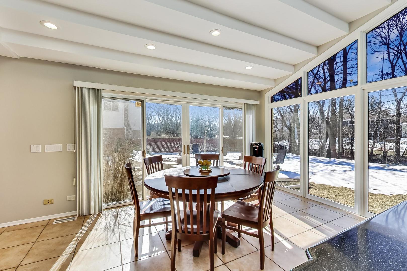 1846 Smith Road Northbrook, IL 60062 - Photo 14 of 58 a dining room with furniture a chandelier and wooden floor