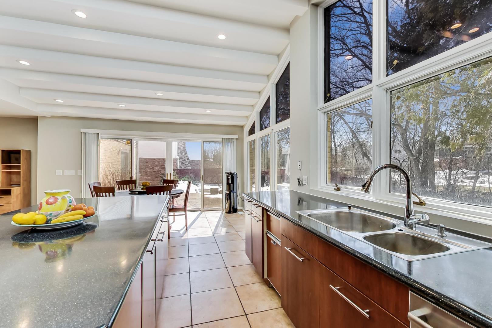 1846 Smith Road Northbrook, IL 60062 - Photo 17 of 58 a kitchen with a sink and living room filled with furniture