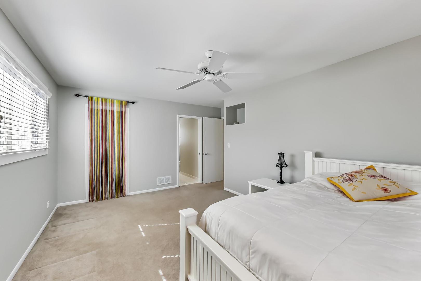 1846 Smith Road Northbrook, IL 60062 - Photo 31 of 58 a bedroom with a bed and a chandelier
