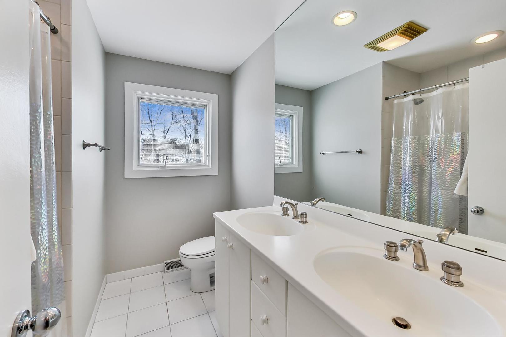 1846 Smith Road Northbrook, IL 60062 - Photo 36 of 58 a bathroom with a sink and mirror with toilet