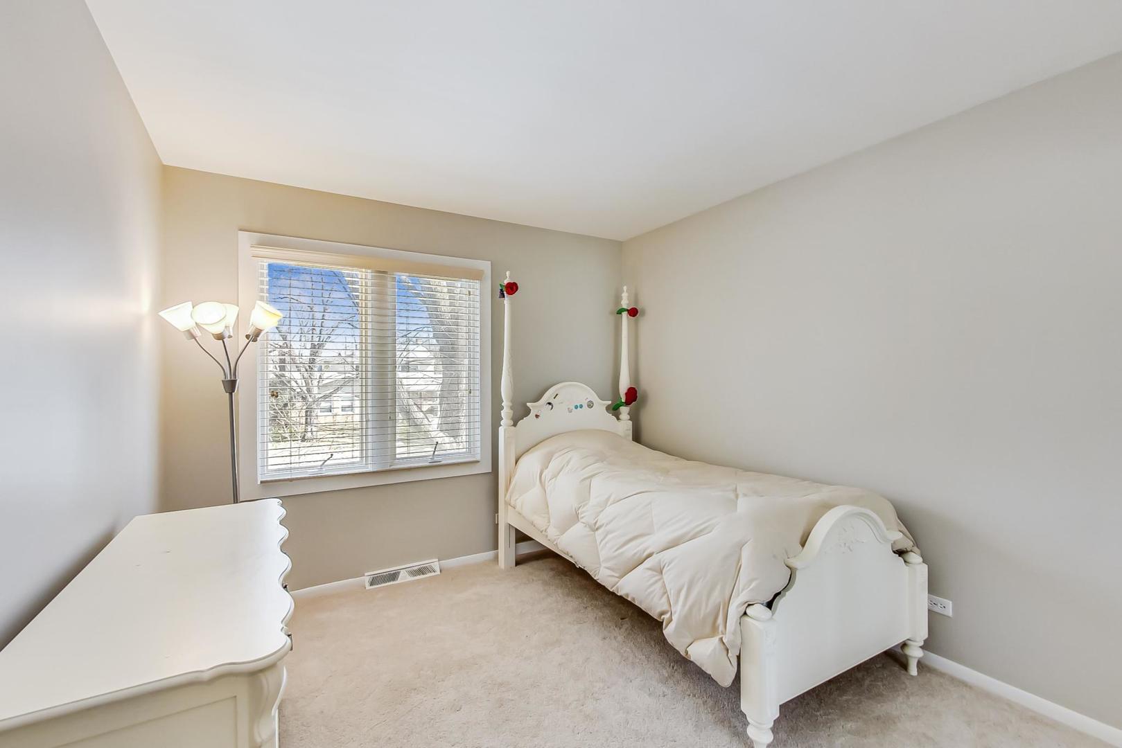 1846 Smith Road Northbrook, IL 60062 - Photo 37 of 58 a bedroom with a bed lamp and a window